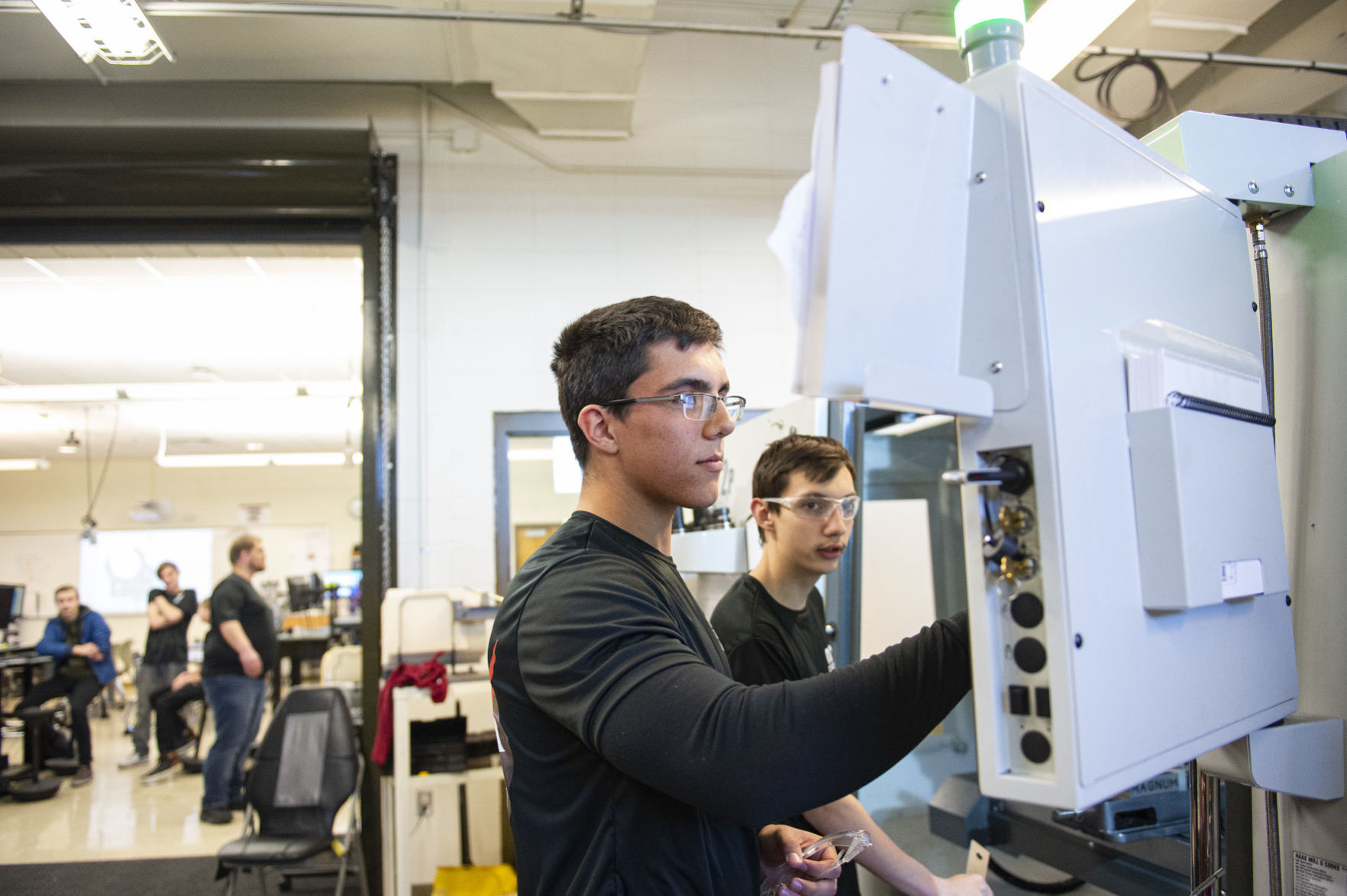 High schoolers making spaceship parts